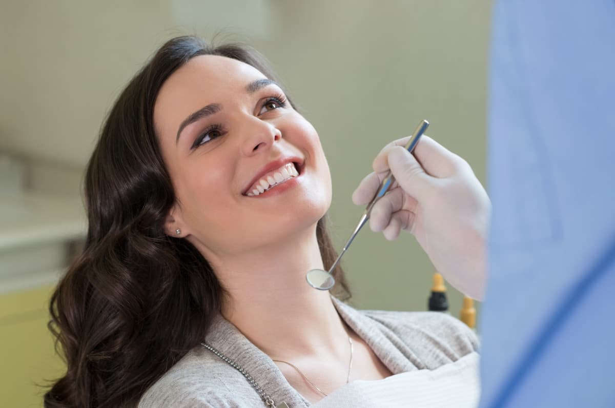Smiling patient receiving preventive dental care during an appointment at SoCal Prime Dentistry.
